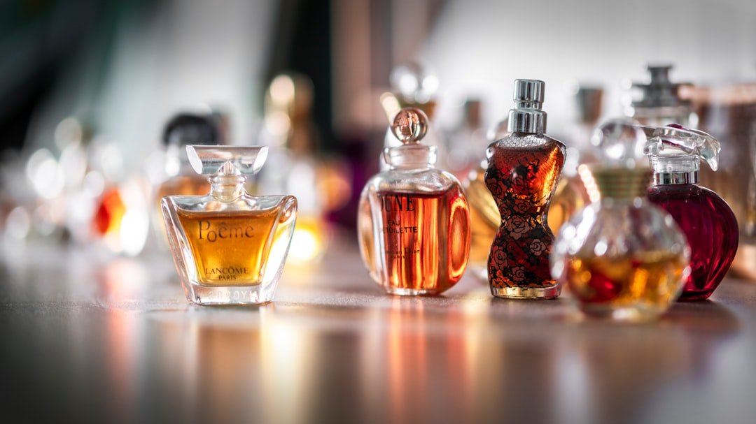 An artistic arrangement of perfume bottles with floral and fruity elements, showcasing the concept of fragrance notes.