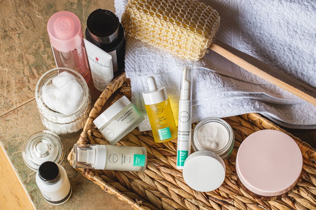 A serene bathroom setting with elegant skincare products arranged neatly on a countertop, featuring a soft towel and natural light.