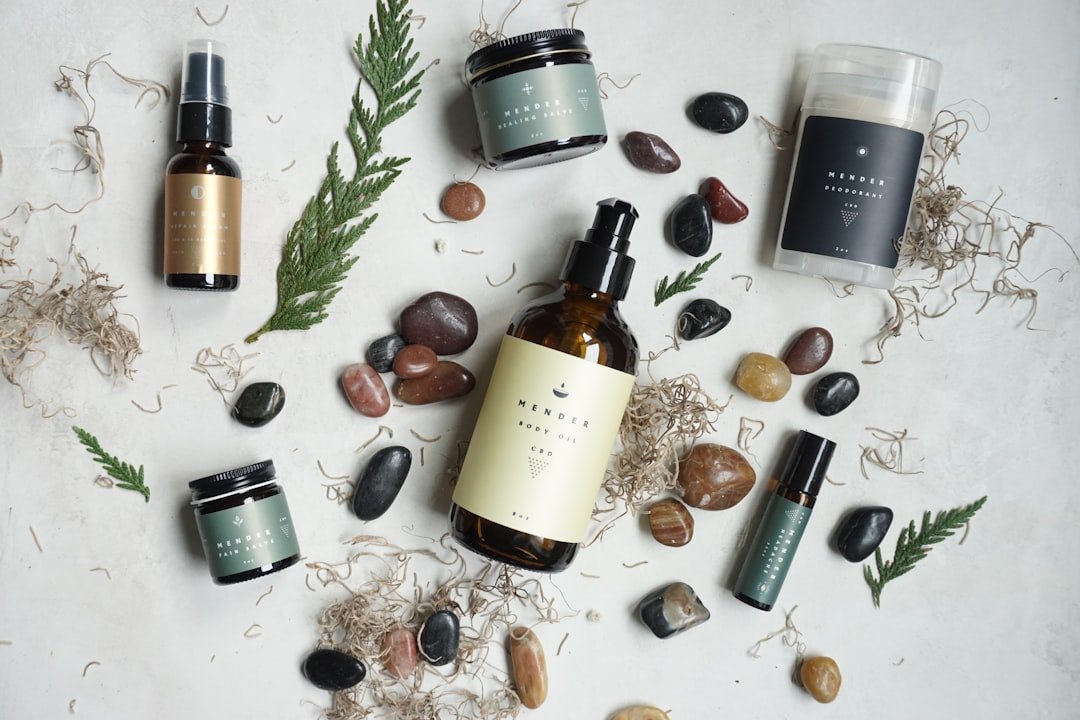 A flat lay of various skincare products including serums, cleansers, and moisturizers on a marble surface.
