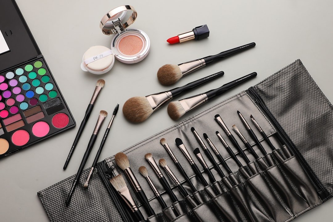 A set of clean makeup brushes arranged neatly on a vanity with soft lighting.