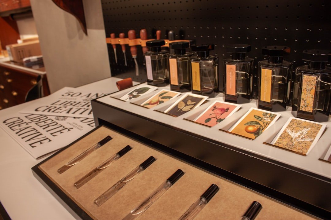 A fragrance display with perfume bottles, sample vials, and illustrated cards depicting floral, fruit, and botanical scent notes.
