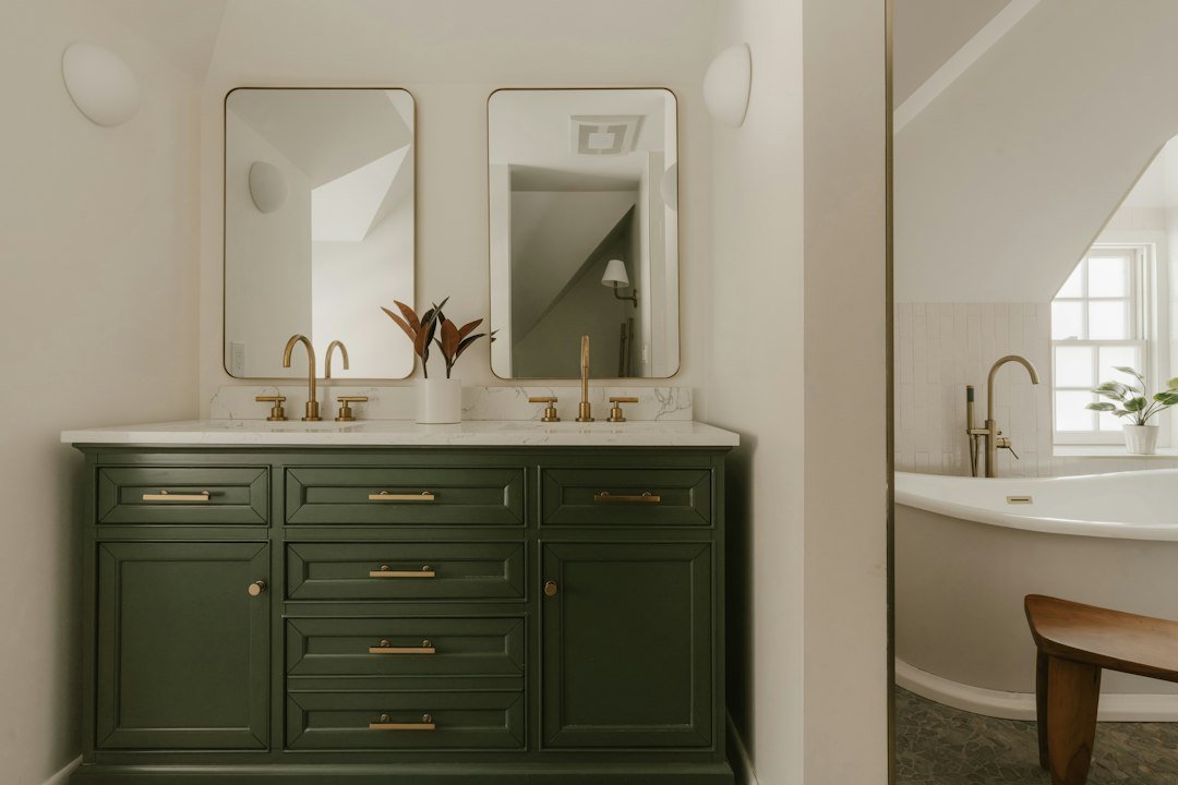A modern bathroom vanity with two sinks and mirrors
