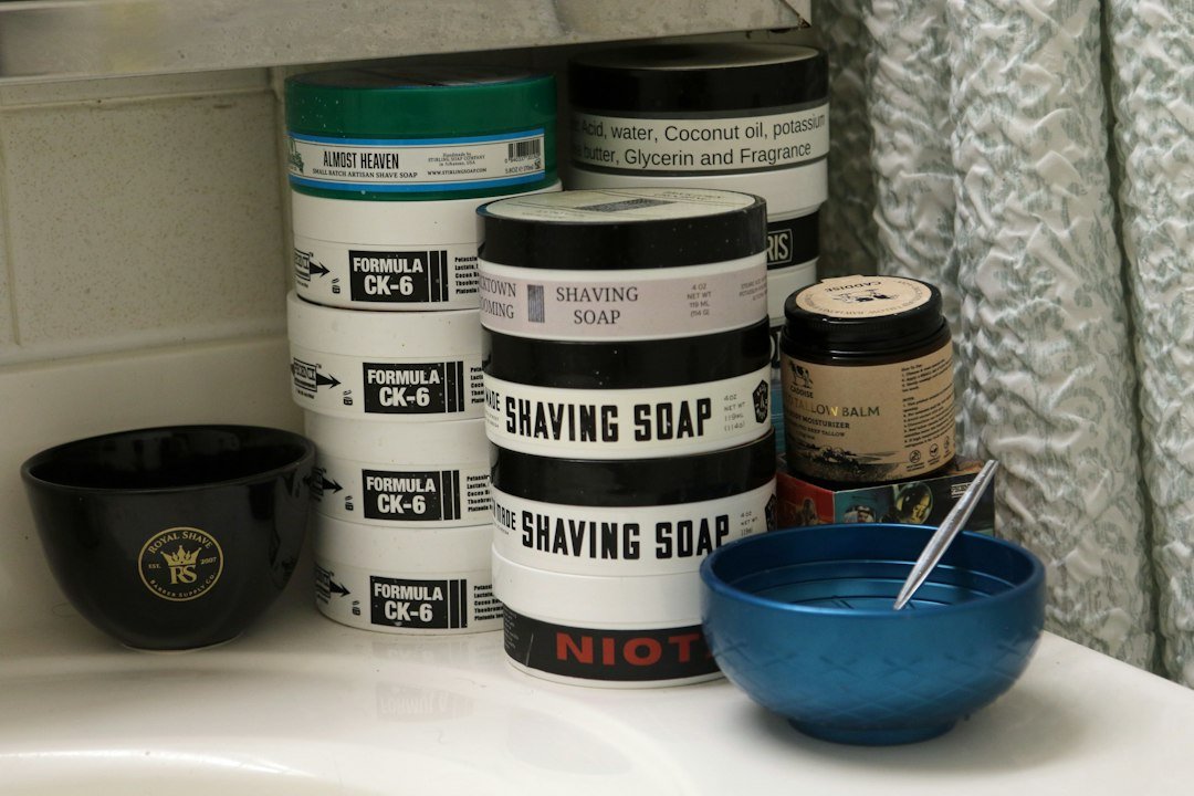 Various shaving soaps and bowls on a bathroom counter